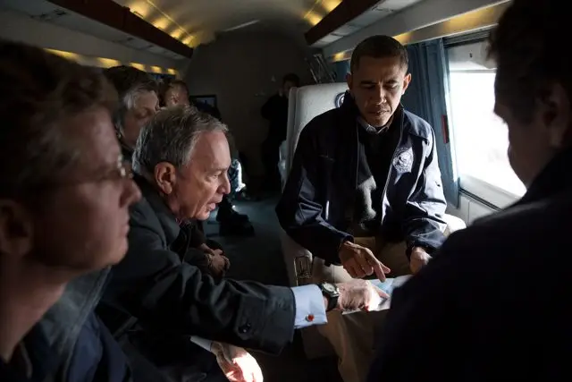 New York Mayor Michael Bloomberg points out areas on a map of the region for President Barack Obama aboard Marine One during an aerial tour of Hurricane Sandy storm damage in New York, N.Y., Nov. 15, 2012
